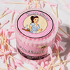 Pink container of Blazy Susan cotton buds surrounded by cotton buds on a light pink background