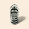 Glass bong with a metallic cap on a beige background