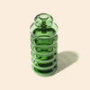Green glass bong with a ribbed design on a beige background