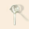 A clear glass NWTN Home Deco Hand Pipe, shown on a solid pale beige background with a soft shadow.