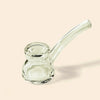 Clear NWTN Home glass water pipe with a curved stem and rounded base, photographed on a plain warm beige background.