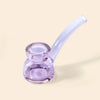 A translucent light purple glass water pipe by NWTN Home with a double-bulb bowl and a curved mouthpiece, set against a solid pale beige background.